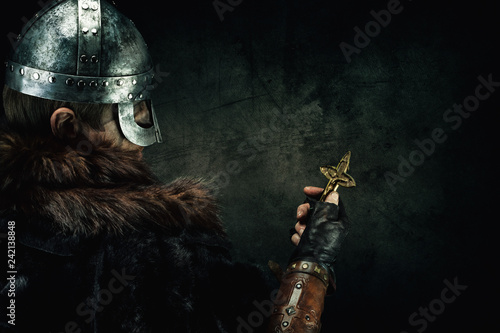 Portrait of a Viking holding a Christian cross in his hand