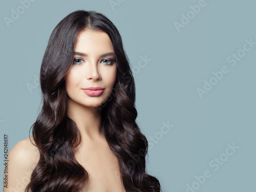Young perfect woman with brown hair on blue background
