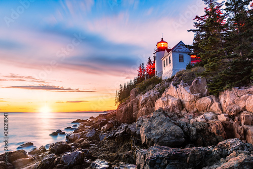 Bass Harbor Head lighthouse at sunset. Bass Harbor Head Light is a lighthouse located within Acadia National Park, Maine, marking the entrance to Bass Harbor and Blue Hill Bay