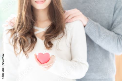 couple holding heart symbol 