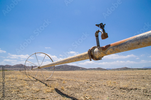 The water irrigation pipes in the dry Southern California farmland. 