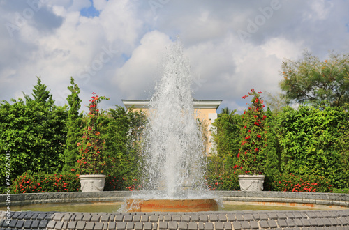 Beautiful fountain in the flower garden.