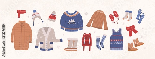 Bundle of knitted winter clothes and outerwear isolated on light background - woolen sweater, cardigan, waistcoat, snow boots, hat, gloves, socks. Set of seasonal clothing. Flat vector illustration.