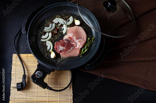 electric pan meat skillet pot connector plug food fry electrical adjustable onion black brown background table