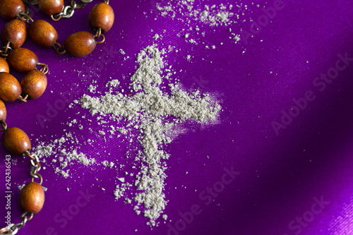 Ash Wednesday religion concept on violet fabric background with rosary 