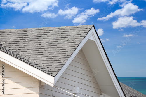 grey roof shingle with blue sky background
