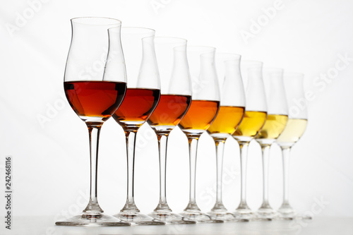 Row of cognac glasses with different stages of aging