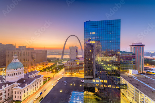 St. Louis, Missouri, USA downtown cityscape with the arch and courthouse at dusk.