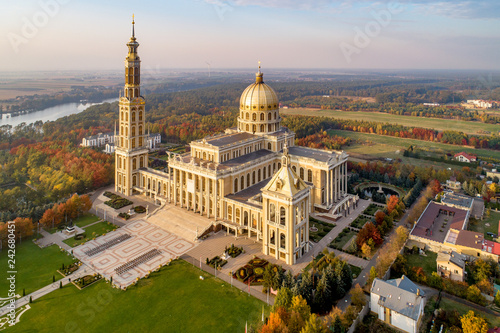 Sanctuary and Basilica of Our Lady of Licheń in small village Lichen. The biggest church in Poland, one of the largest in the World. Famous Catholic pilgrimage site. Aerial view in fall. Sunset light