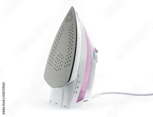 Steam iron laid on white background, elegant pastel pink model