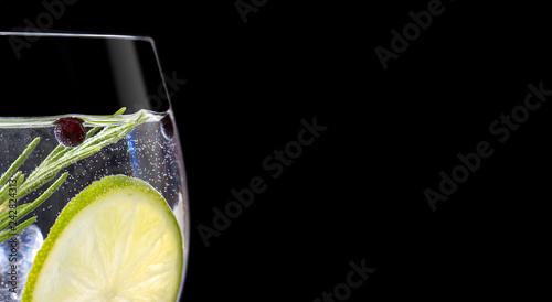 Close up of gin tonic glass on black background