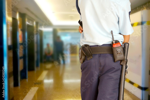 Security guards control the indoor entrance door