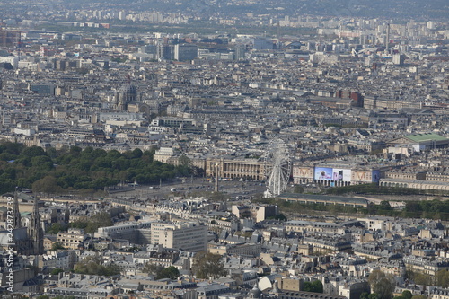 Top view of different houses and buildings as well as the Ferris wheel in Paris