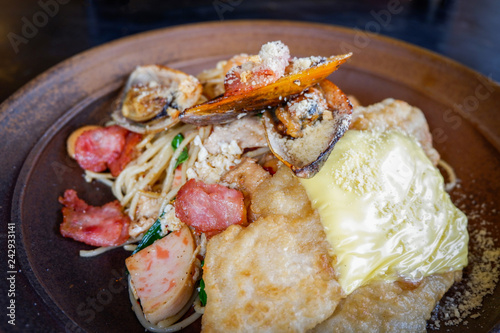 spaghetti cabonara plate - fresh spaghetti pasta with seafood fish mussel bacon and egg