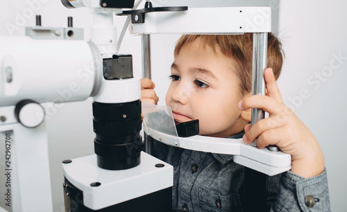 optometrist performing visual field test to little patient