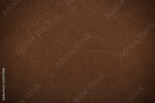 Textured background of felt fiber brown with vignette