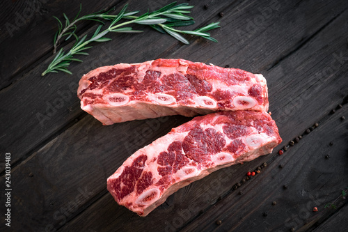 raw beef ribs kalbi on wooden background, top view