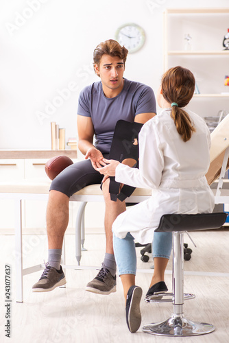 Handsome american footbal player visiting female doctor traumato