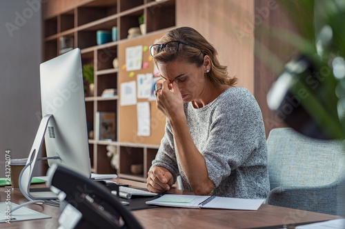 Business woman having headache at office