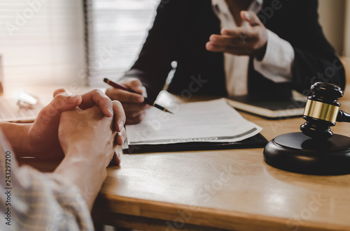 legal consultants, notary or justice lawyer discussing contract document with customer and wooden judge gavel on desk in courtroom office, business, justice law, insurance and legal service concept