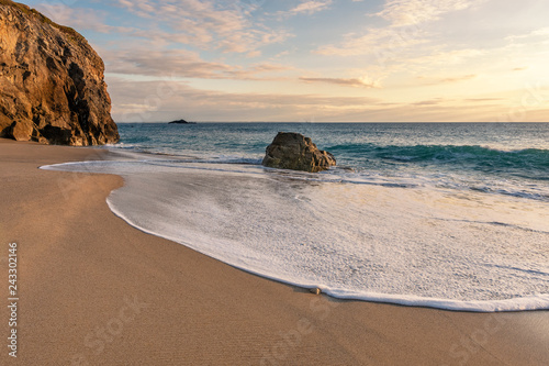 French landscape - Bretagne. A beautiful beach with wild cliffs in the background at sunset.