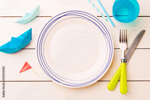 Table setting for kids - empty plate with decorations around