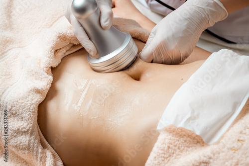 Hardware cosmetology. Body care. Spa treatment. Ultrasound cavitation body contouring treatment. Woman getting anti-cellulite and anti-fat therapy in beauty salon.