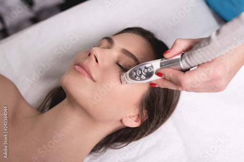 Lymphatic drainage massage LPG apparatus process. Therapist beautician makes a rejuvenating facial massage for the woman in a SPA salon. Beauty and bodycare concept.