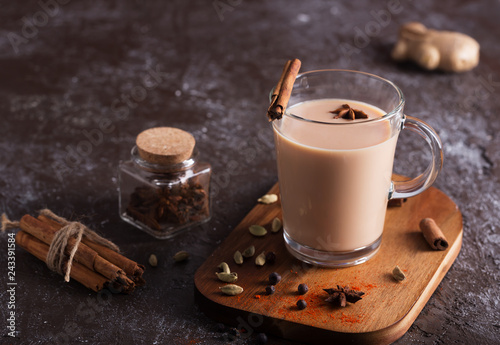 Masala chai tea on the dark background. Hot indian beverage with spices