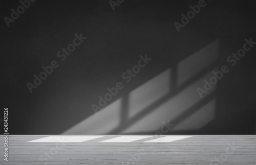 Black wall in an empty room with concrete floor