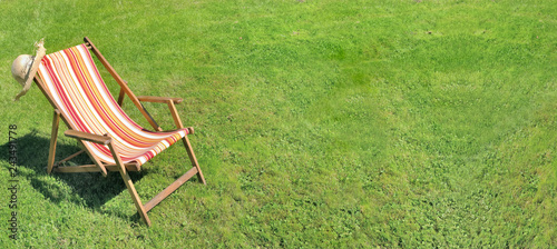 deckchair on greenery grass in a garden in panoramic size 