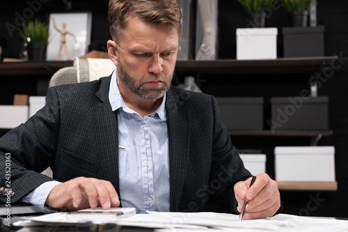 Businessman sitting at computer Desk and thinking about documents