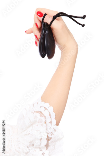 Woman's hand with castanets over white background