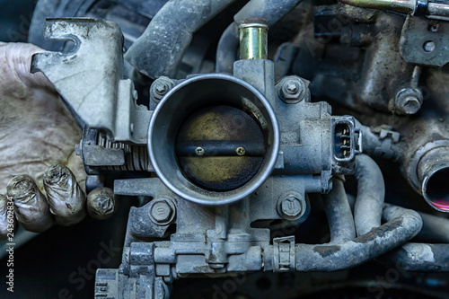 Close-up of the engine, throttle, raditor. Engine breakdown: contaminated throttle of an old car