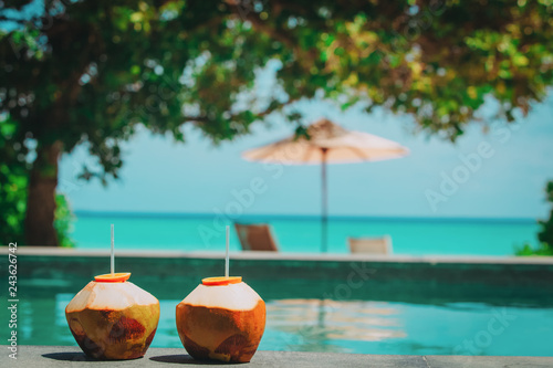 two coconut drinks on tropical beach resort