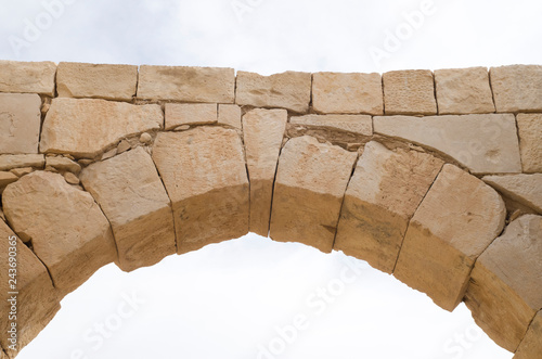 Ancient stone arch and keystone in the sky