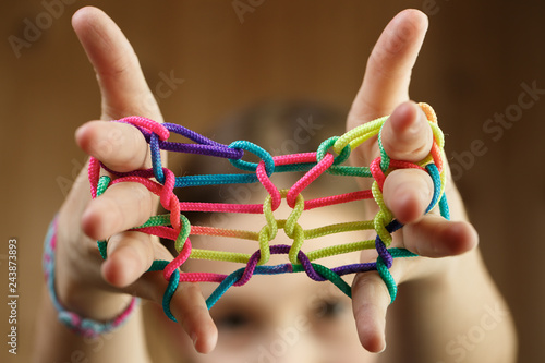 Girl playing classic string game, creating shapes