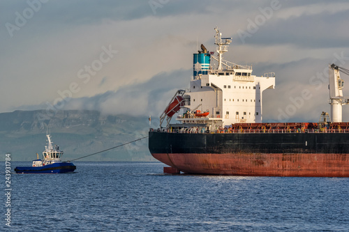 Tugboat pulling a Cargo Ship