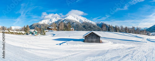 Wide panoramic view of winter landscape with snow covered trees and Alps in Seefeld in the Austrian state of Tyrol. Winter in Austria