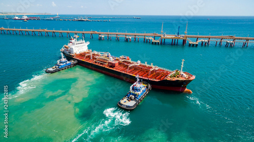 tanker moored to the port using tugs