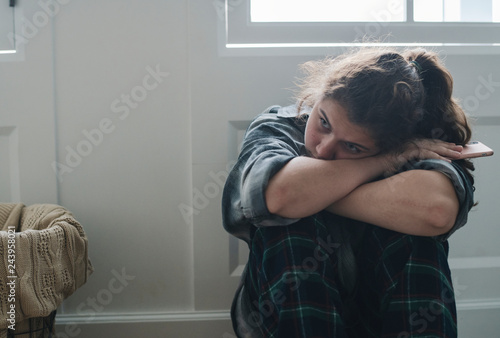 Girl sitting alone and sad in her room