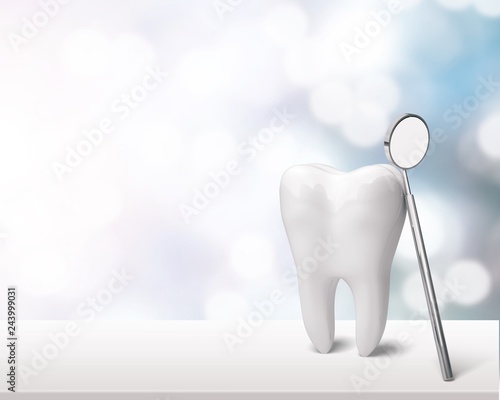 Big tooth and dentist mirror on table