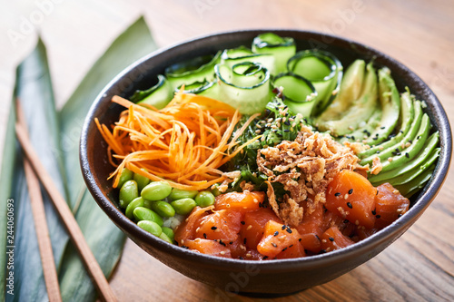 Poke bowl on wooden background