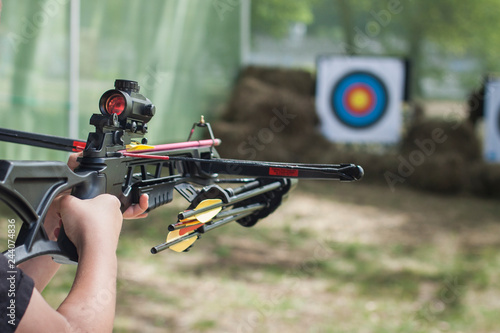 The shooter directed the crossbow towards the colored target. Hit the target. Shooting range