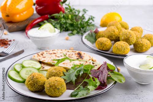 Homemade falafel balls,sweet red pepper and green fresh parsley. Traditional Middle Eastern food.