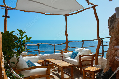 table and chairs with shade sails on the beach