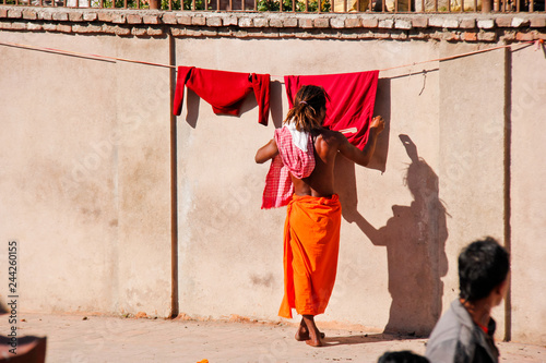 Monk in Nepal hang up his clothes to dry