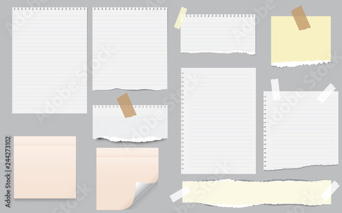 White and colorful note, notebook paper with torn edges stuck on gray background. Pink sheets of note papers, sticky notes