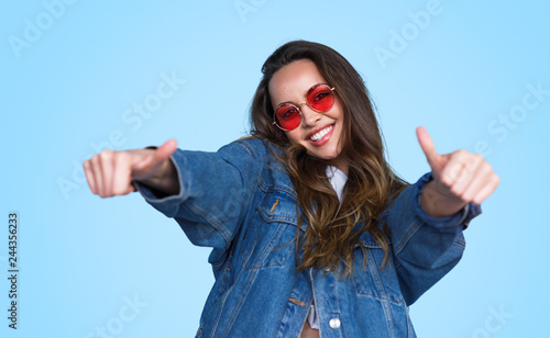 Bright teenage girl showing thumbs up