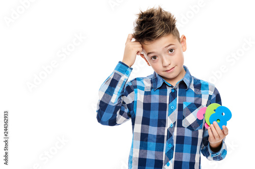 Cute boy with dyscalculia holding large colorful numbers and scratching his head. Learning disability concept on white background.